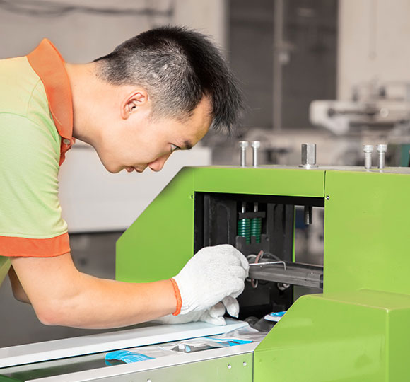 A worker is maintaining a packaging mahcine