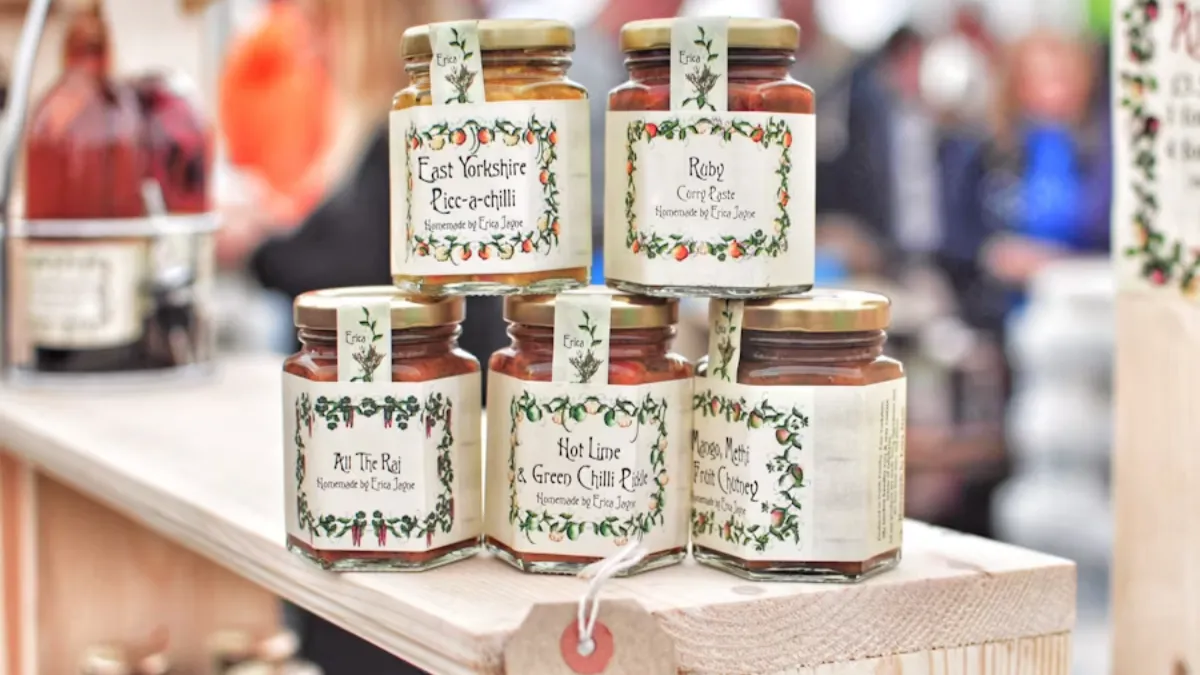 selective focus photo of five glass jars on brown wooden table
