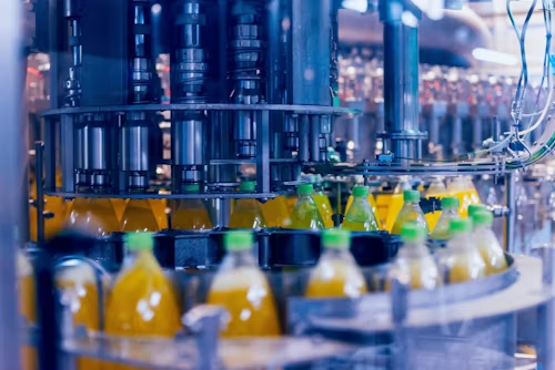 automatic-filling-machine-pours-water-into-plastic-pet-bottles-brewing-production-industrial-background