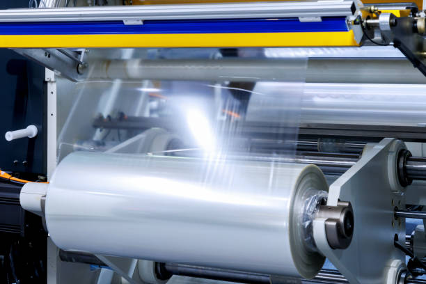 roll of plastic packaging film on the automatic packing machine in food product factory