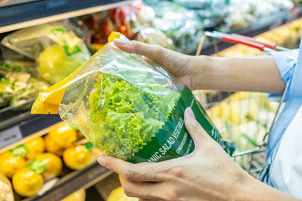 Close up of asian woman hands holding a package of fresh green